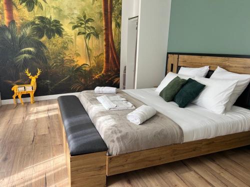 a bedroom with a large wooden bed with green pillows at La Maison Cabane in Cholet