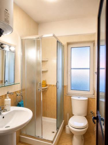 a bathroom with a shower and a toilet and a sink at Sea view apartment 1 in Shëngjin