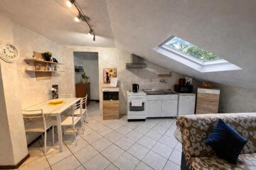 a kitchen and living room with a table and a window at Casa LOUES in Asti