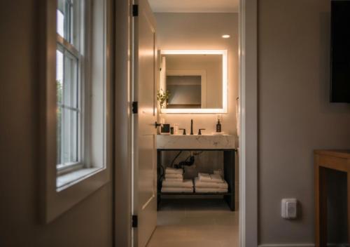a bathroom with a sink and a mirror at The Cape Club Golf Resort in Falmouth