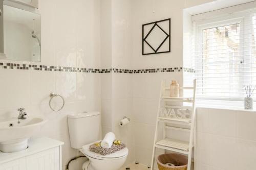a white bathroom with a toilet and a sink at 2 Bed in Shanklin oc-c36037 in Shanklin