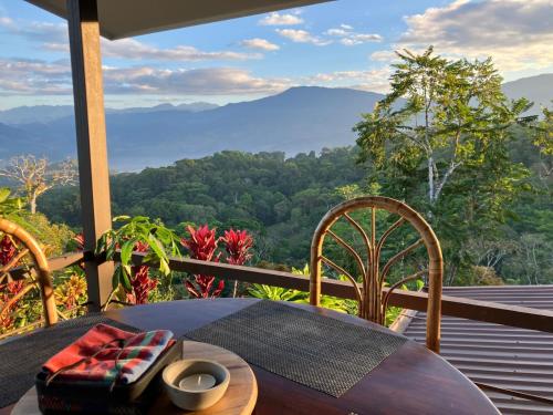 a table and chairs on a balcony with a view at Luxury In The Jungle in Barú