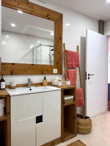 a kitchen with a sink and a mirror at Bruma do Pico House in Lajes do Pico