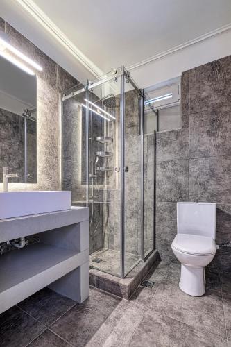 a bathroom with a shower and a toilet and a sink at Apollo Romantic Sea View Villa in Kiveri