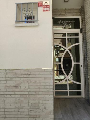 a door to a store with a sign on it at Apartamentos Dali 1 in Guadix