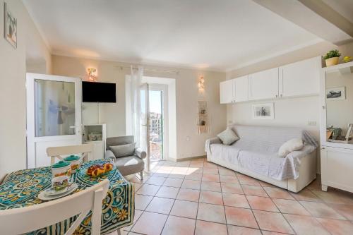a living room with a bed and a table at Nido Belvedere AC and Lake View - Happy Rentals in Lesa