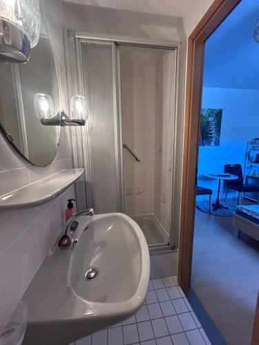 a bathroom with a sink and a shower at Gästehaus Gute Quelle in Cochem