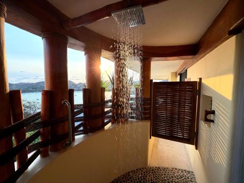 a bathroom with a tub with a view of the ocean at Tentaciones Boutique Hotel - Ocean View & Private Pools - Adults Only in Zihuatanejo
