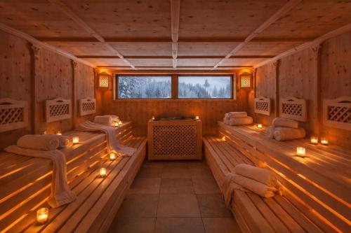 a sauna with benches and candles in it at Appartement Swing in Mittelberg