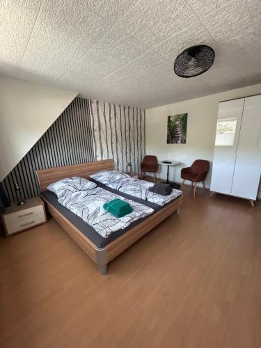 a bedroom with a bed and a table and chairs at Gästehaus Gute Quelle in Cochem