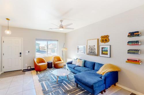 a living room with a blue couch and orange chairs at The Pine House in Flagstaff