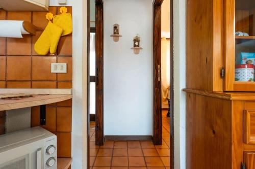 a kitchen with a door leading into a kitchen with a counter at Il Posto Giusto in Costa Rei