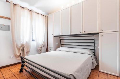 a bedroom with a bed and white cabinets at Il Posto Giusto in Costa Rei