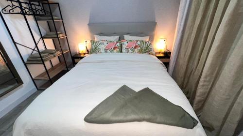 a bedroom with a large bed with a green pillow on it at Villamadrid Home 2 in Madrid