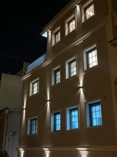 a building with lights on the side of it at night at Strettorooms in Villa San Giovanni