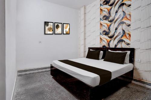 a bedroom with a bed in a white room at Hotel O Vishal Residency in New Delhi