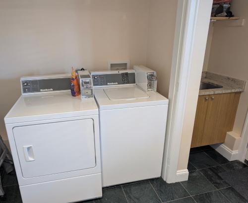 a kitchen with a dishwasher and a washer and dryer at Private Room in Guest House, Near the New Oakridge Mall & Transit - Near Langara 49th Station in Vancouver