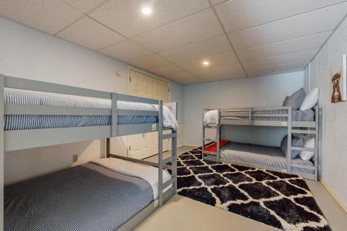 a room with two bunk beds and a carpet at Sprawling Eufaula Lake Sanctuary w/ Dock! in Texanna