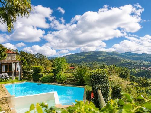a villa with a swimming pool and mountains in the background at Casa Love Story - Piscina, Sauna & Jacuzzi in Arcos de Valdevez