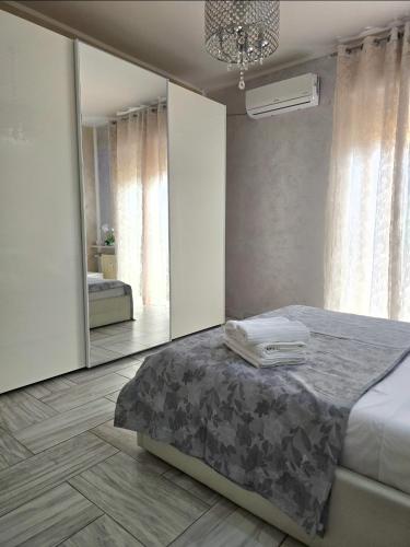 a bedroom with a bed and a large mirror at Alloggio Acqui in Acqui Terme