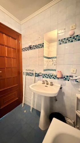 a bathroom with a white sink and a mirror at Villa Terrazos in Terrazos