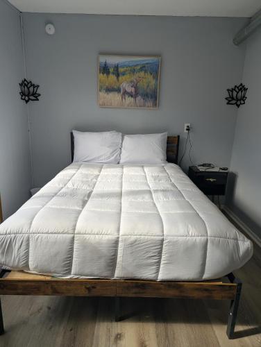 a bedroom with a large bed with white sheets at Fresh start small breakfast cook and serve your self in Lubbock