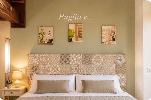 a bedroom with a large white bed with a wall at Villa Adriana - Private Pool Villa in Puglia in Andria