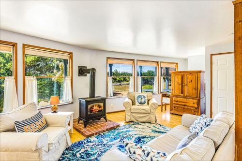 a living room with a couch and a fireplace at Cozy Copalis Beach Cottage Escape in Copalis Beach