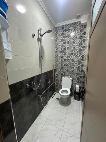 a bathroom with a shower and a toilet in it at شقة مفروشة للكراء اكادير للعائلات فقط in Agadir