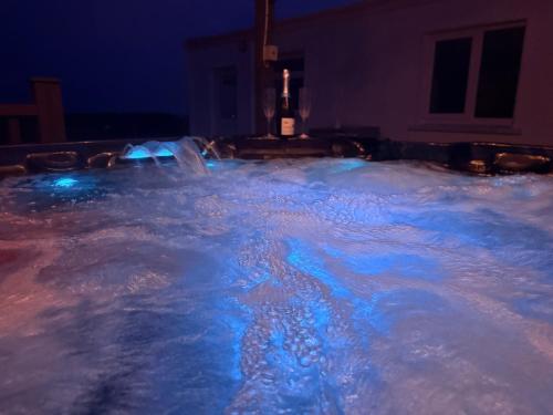 a bath tub filled with snow at night at The Cottage in Ballaghaderreen