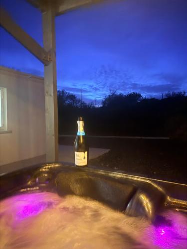 a bottle of alcohol sitting on the ledge of a window at The Cottage in Ballaghaderreen