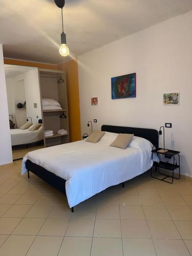 a bedroom with a large bed and a mirror at Holidays House Il Vicoletto in Sulmona