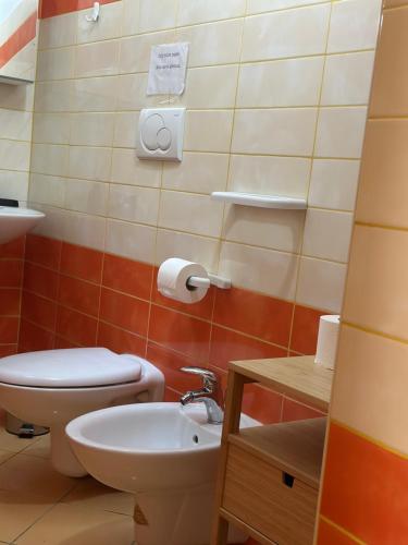 a bathroom with a toilet and a sink at Holidays House Il Vicoletto in Sulmona