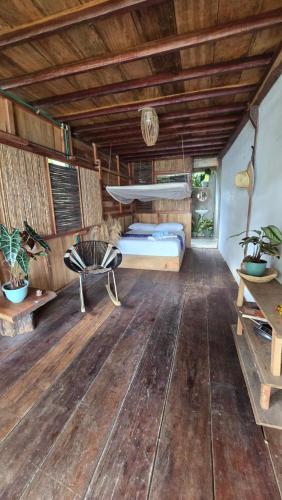 a bedroom with a bed and a wooden floor at El cielo hotel isla fuerte in Puerto Limón