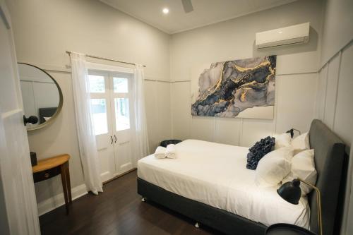 a bedroom with a bed and a window at The Foxman Cottage in Broke
