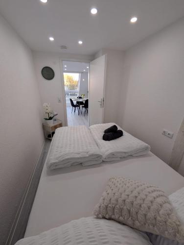two twin beds in a room with a table at Lovely Home For You 2 in Biberach an der Riß