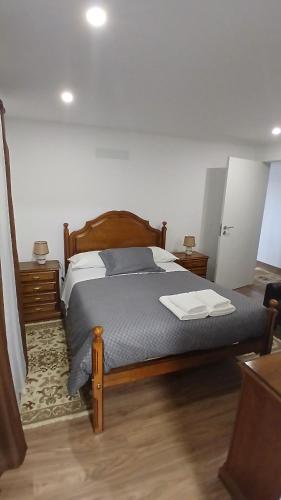 a bedroom with a bed with two towels on it at Casa Do Olival in São João da Pesqueira