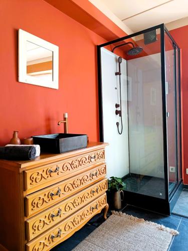 a bathroom with a sink and a mirror at Aux 1001 Nuits Marrakech's touch in Chapelle-lez-Herlaimont
