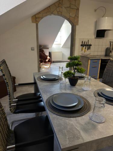 a table with plates on it in a kitchen at Casa Antic Große Moderne 45qm wohnung im Zentrum Am Bahnhof Kostenloses WLAN in Saalfeld