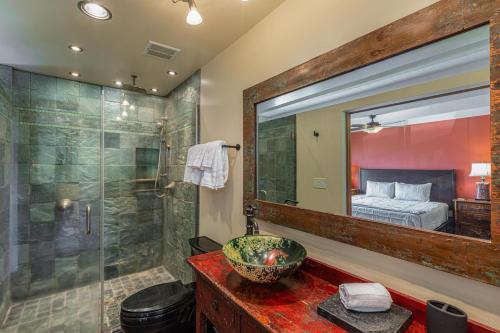 a bathroom with a shower and a sink and a mirror at Puamana 19C in Princeville