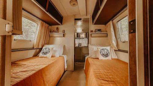 a small room with two beds in a trailer at Urban Airstream Retreat in Memphis