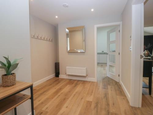 a living room with white walls and wooden floors at Cross Winds in Lancaster