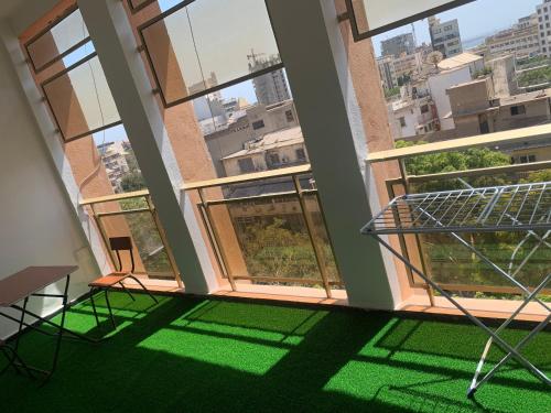 a room with large windows and a green floor at Central Dakar plateau apartment in Dakar