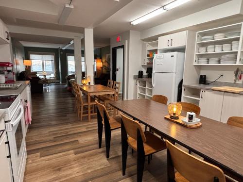 a kitchen and dining room with a table and chairs at Jasper East Hostel - Near Jasper National Park East Gate Entrance in Jasper