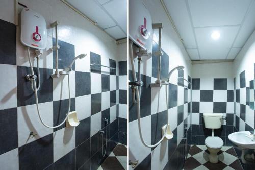a bathroom with a black and white checkered wall at perfect class hotel in Kuala Lumpur