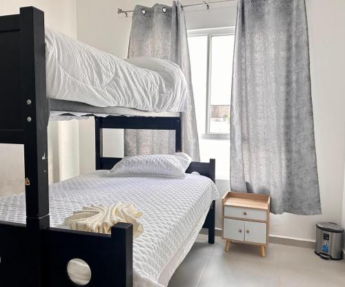 a bedroom with a black bunk bed and a window at Casa en Paseo San Junipero in San José el Alto