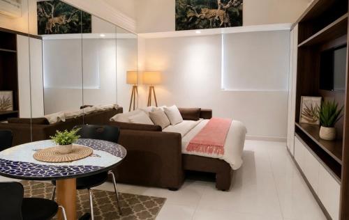 a living room with a couch and a table at Tropical Executive Hotel in Manaus