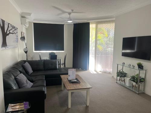 a living room with a couch and a coffee table at Serenity in Surfers Paradise in Gold Coast