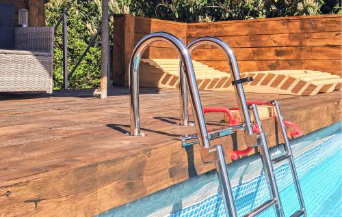 a slide in a pool with a wooden deck at Hunting Lodge in Detern