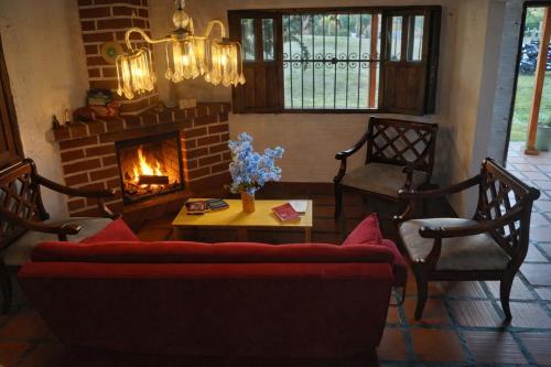 a living room with a couch and a fireplace at Casa Campestre Familiar in Medellín